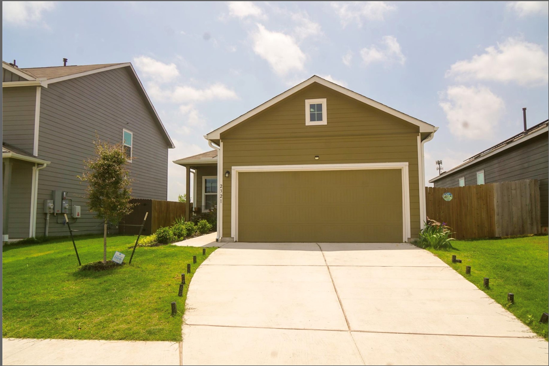 2321 Forgetmenot Lane Manor, TX 78653 - Photo 1 of 27 A newly constructed residence features a well-maintained driveway leading to an attached garage.