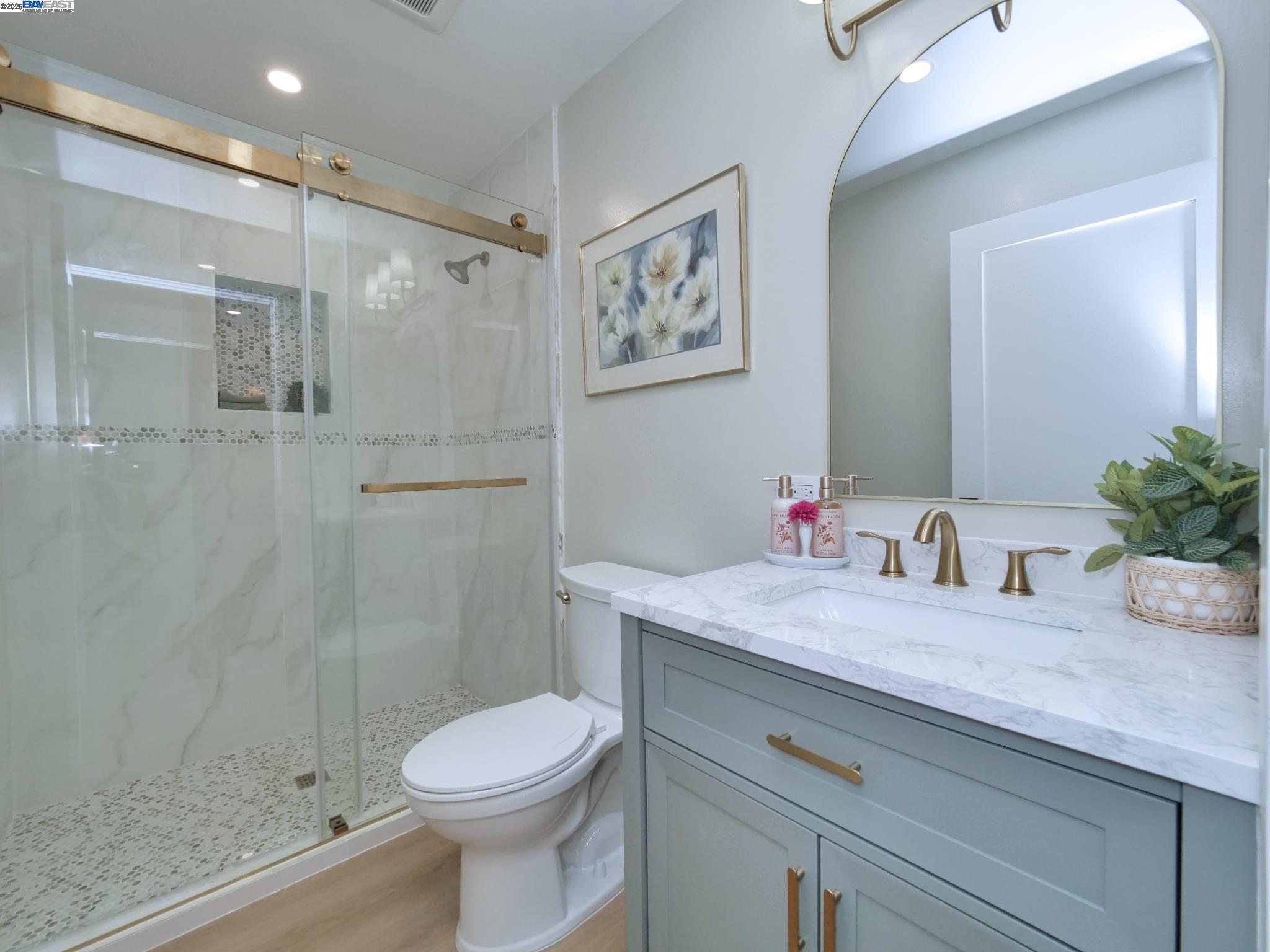 1732 Oakmont Drive, Unit 8 Walnut Creek, CA 94595 - Photo 13 of 23 a bathroom with a granite countertop sink a toilet and shower