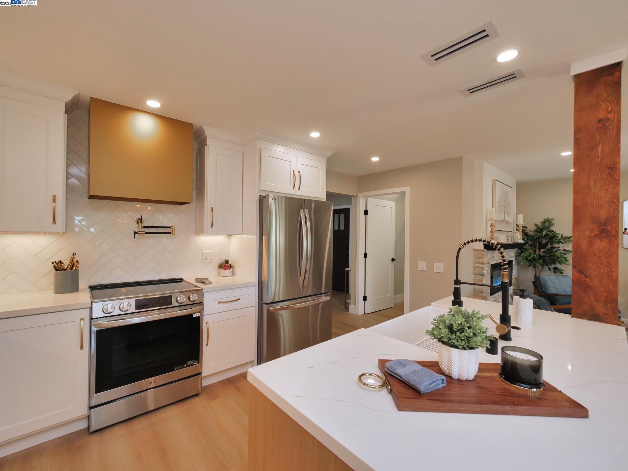 1732 Oakmont Drive, Unit 8 Walnut Creek, CA 94595 - Photo 6 of 23 a kitchen with sink a refrigerator and chairs