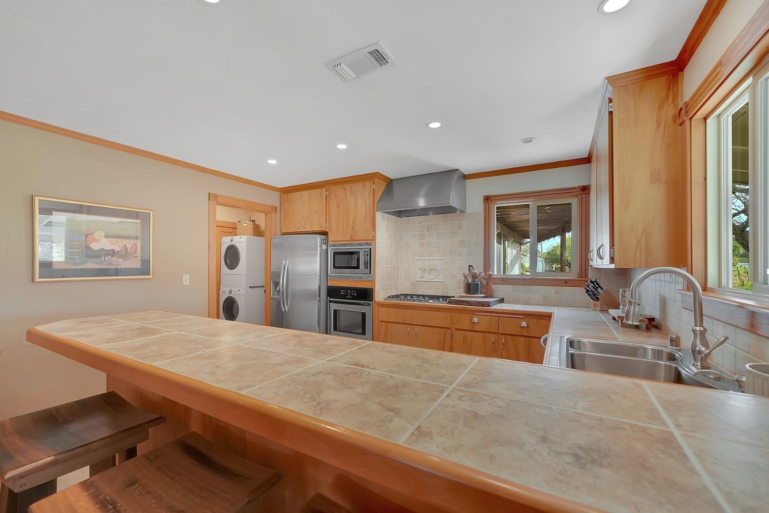 10801 Shenandoah Road Plymouth, CA 95669 - Photo 13 of 45 a large kitchen with stainless steel appliances granite countertop a sink and a refrigerator