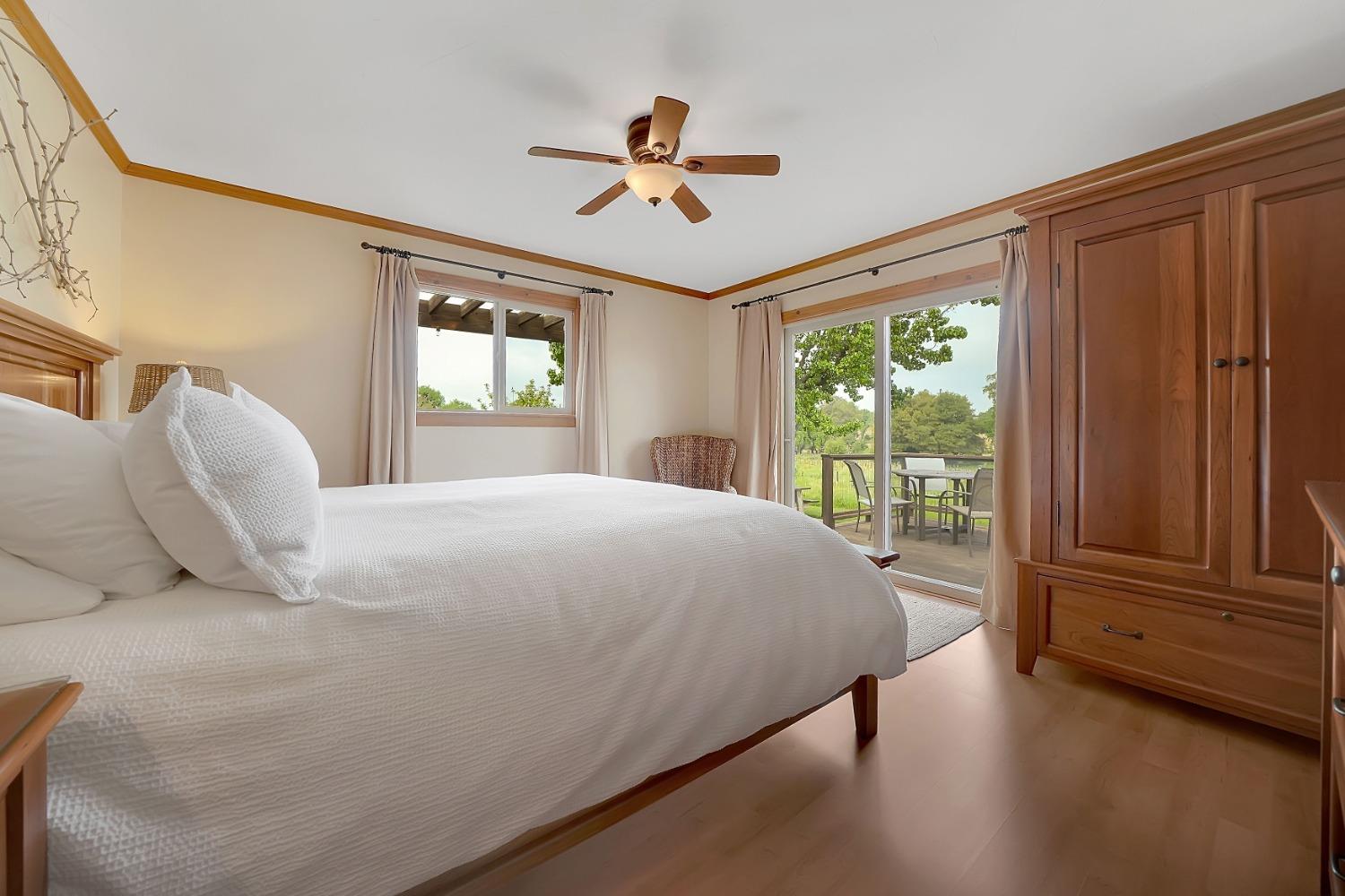 10801 Shenandoah Road Plymouth, CA 95669 - Photo 19 of 45 a bedroom with a bed and wooden floor