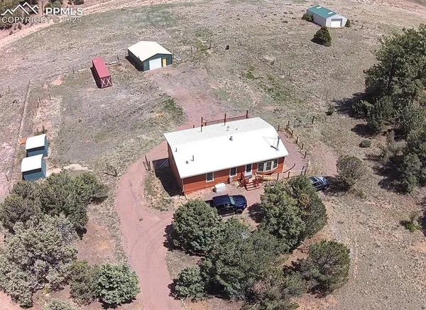 an aerial view of a house with a yard