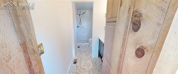 a bathroom with a granite countertop shower and a mirror
