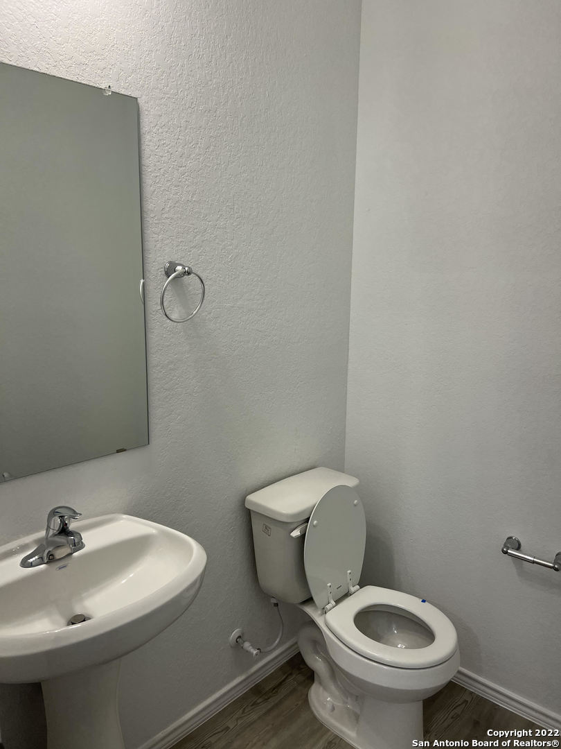 2164 Griffith Drive Seguin, TX 78155 - Photo 12 of 21 a white toilet sitting next to a bathroom sink