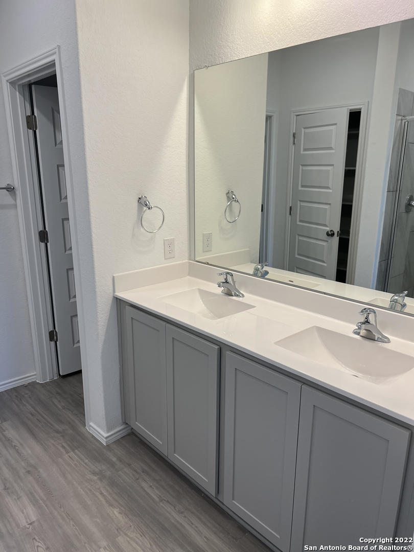 2164 Griffith Drive Seguin, TX 78155 - Photo 18 of 21 a bathroom with a double vanity sink and a mirror