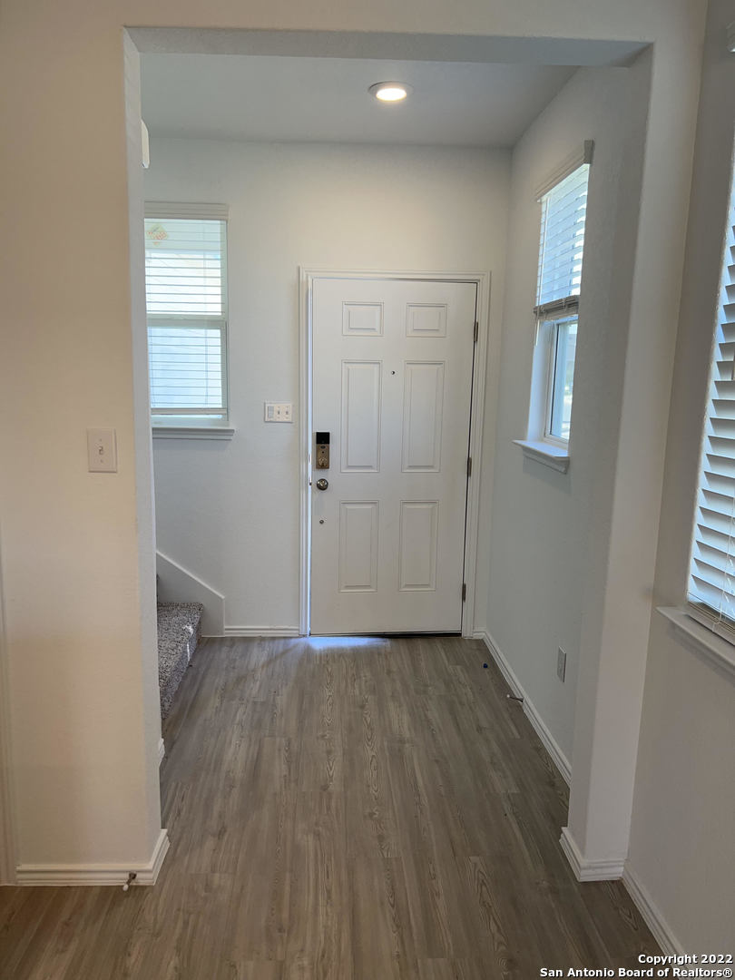 2164 Griffith Drive Seguin, TX 78155 - Photo 4 of 21 an empty room with wooden floor and windows