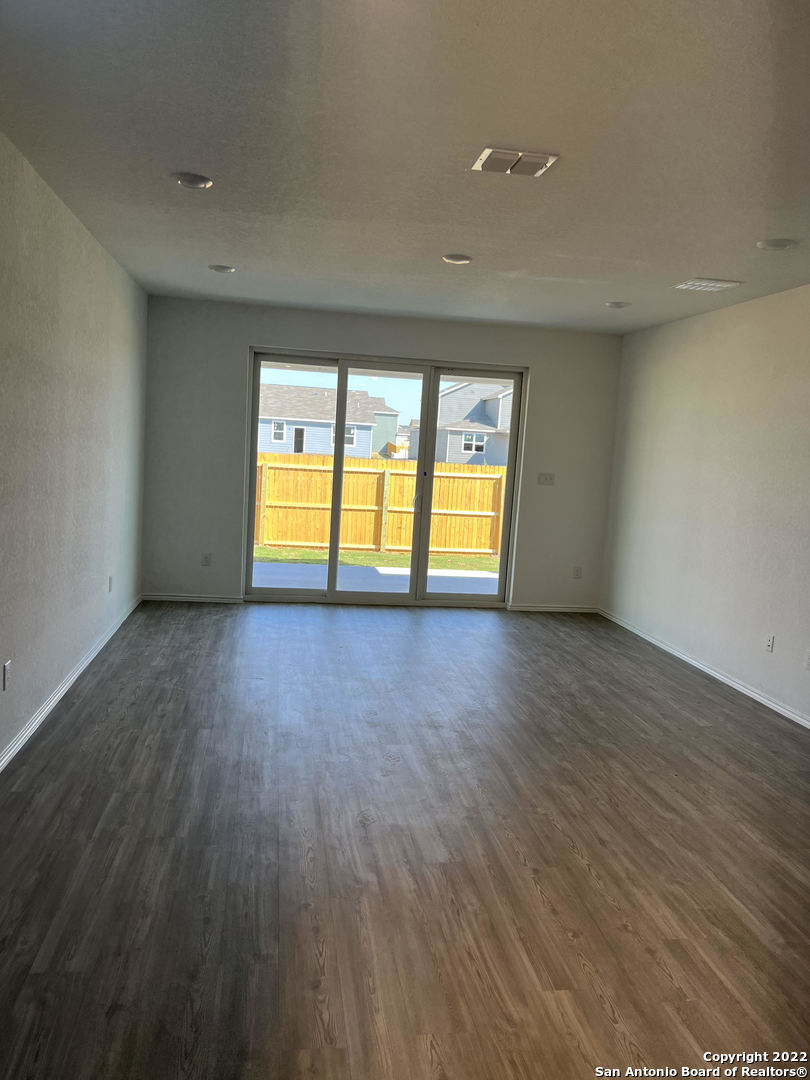 2164 Griffith Drive Seguin, TX 78155 - Photo 5 of 21 a view of an empty room with wooden floor and a window
