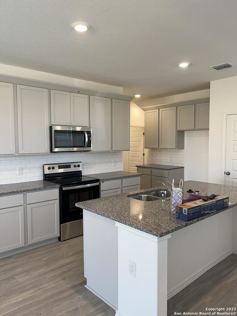 2164 Griffith Drive Seguin, TX 78155 - Photo 7 of 21 a kitchen with sink a microwave and cabinets