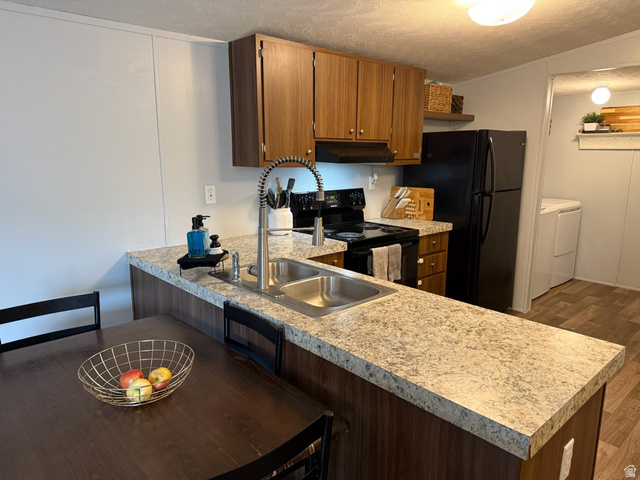 275 North Main Street, Unit 31 Centerfield, UT 84622 - Photo 2 of 13 Kitchen featuring a textured ceiling, a peninsula, black appliances, and light countertops