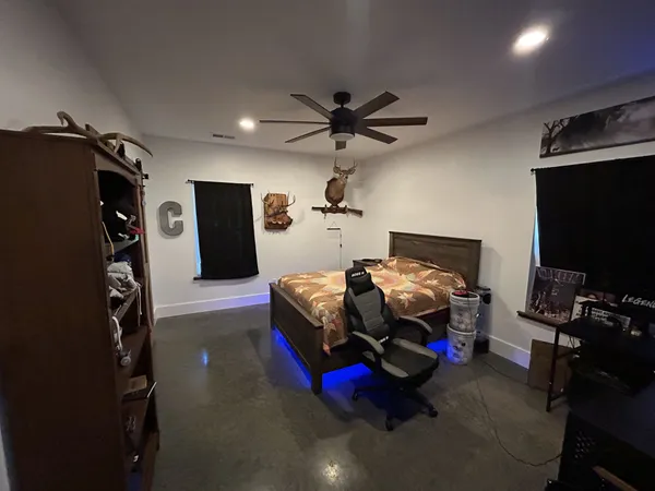 a bedroom with furniture and a flat screen tv