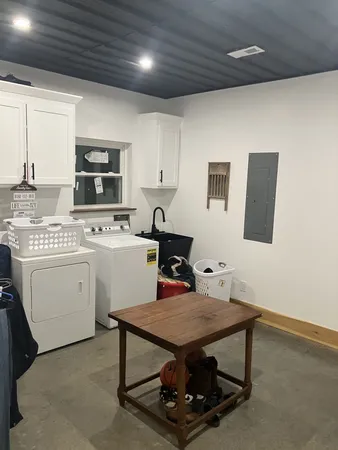 a room with furniture a flat screen tv and a stove