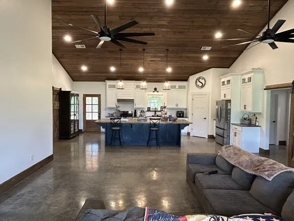 a living room with furniture and kitchen view