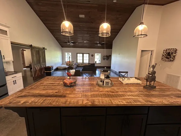 a kitchen with kitchen island granite countertop a stove and a sink
