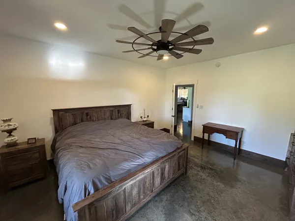 a bedroom with a bed and a chandelier