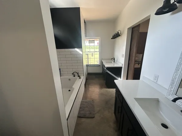 a bathroom with a sink a mirror and a shower