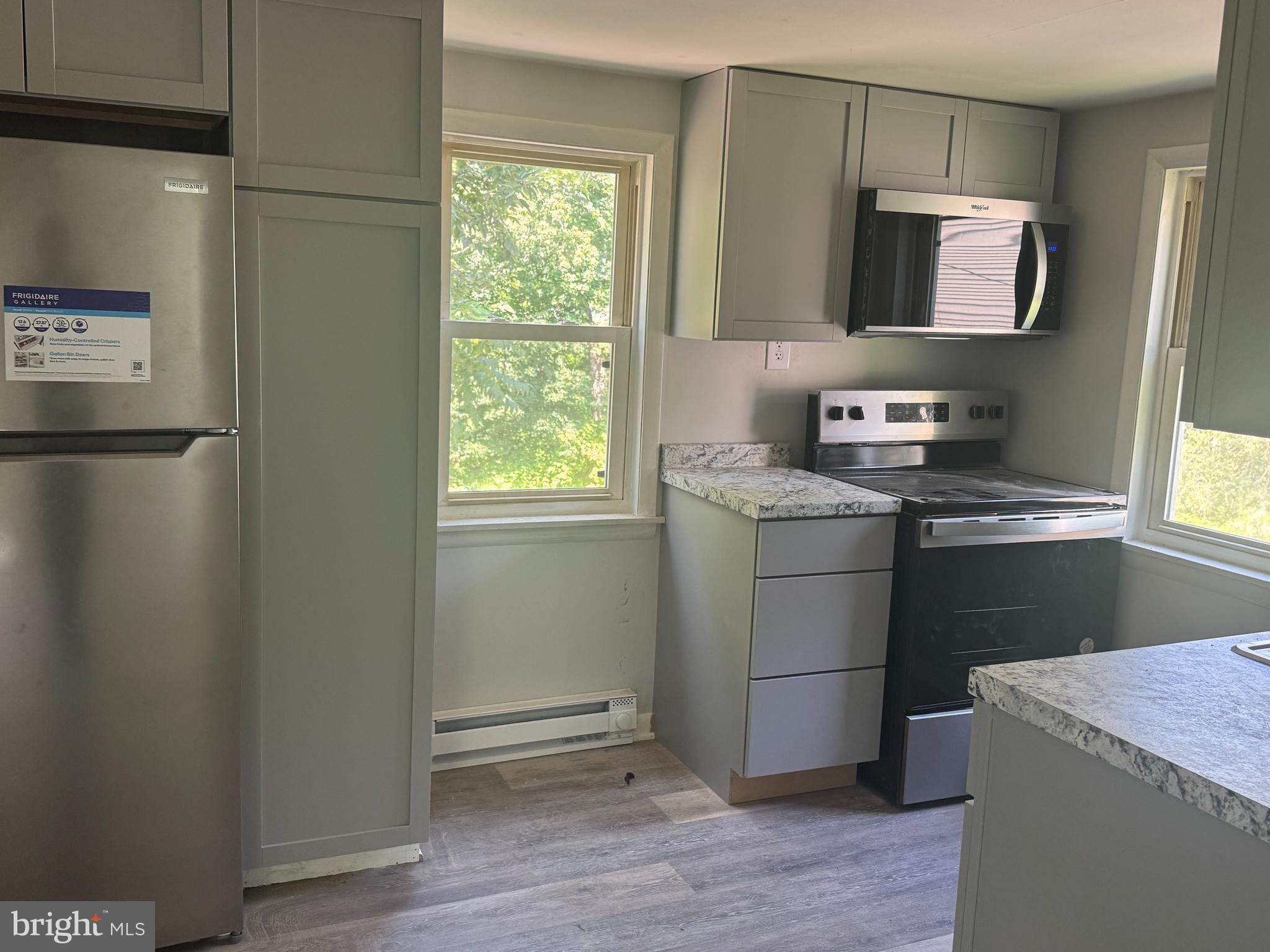 3145 Zepp Road Green Lane, PA 18054 - Photo 3 of 8 a kitchen with a refrigerator and a stove top oven