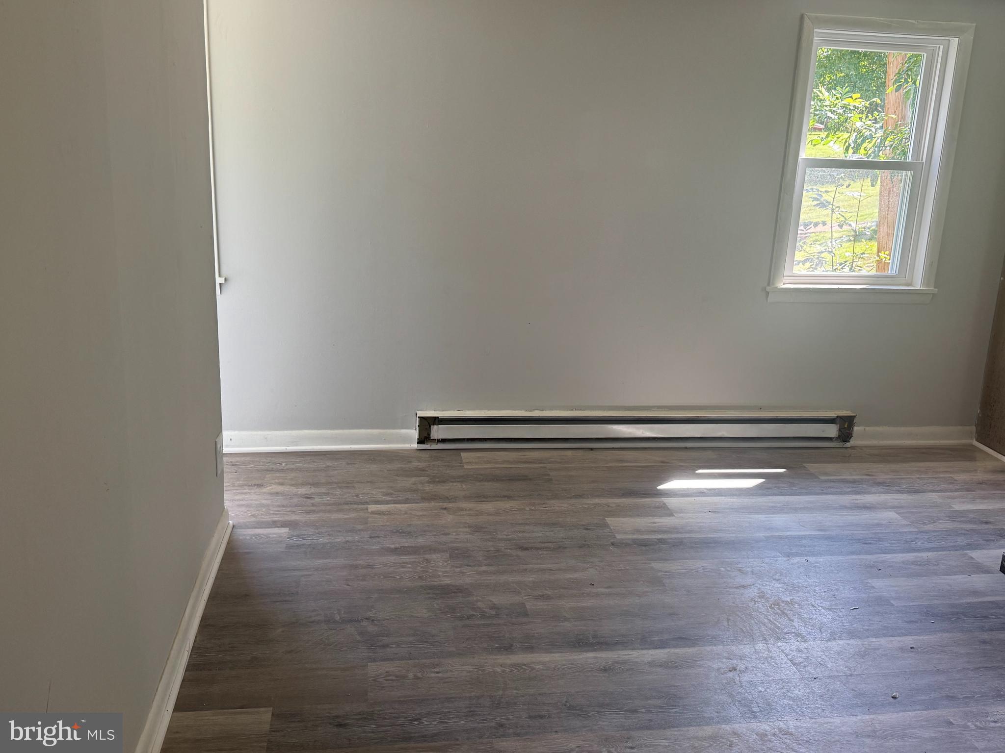 3145 Zepp Road Green Lane, PA 18054 - Photo 6 of 8 an empty room with wooden floor and windows