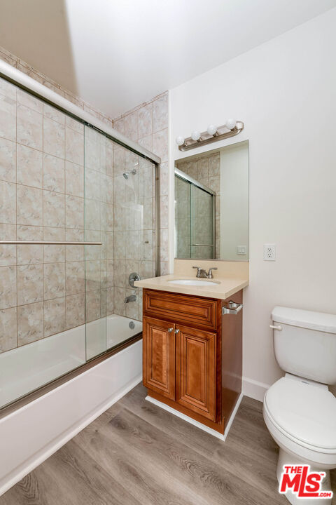 14735 Friar Street, Unit 113 Van Nuys, CA 91411 - Photo 14 of 16 a bath room with a toilet a sink and a mirror