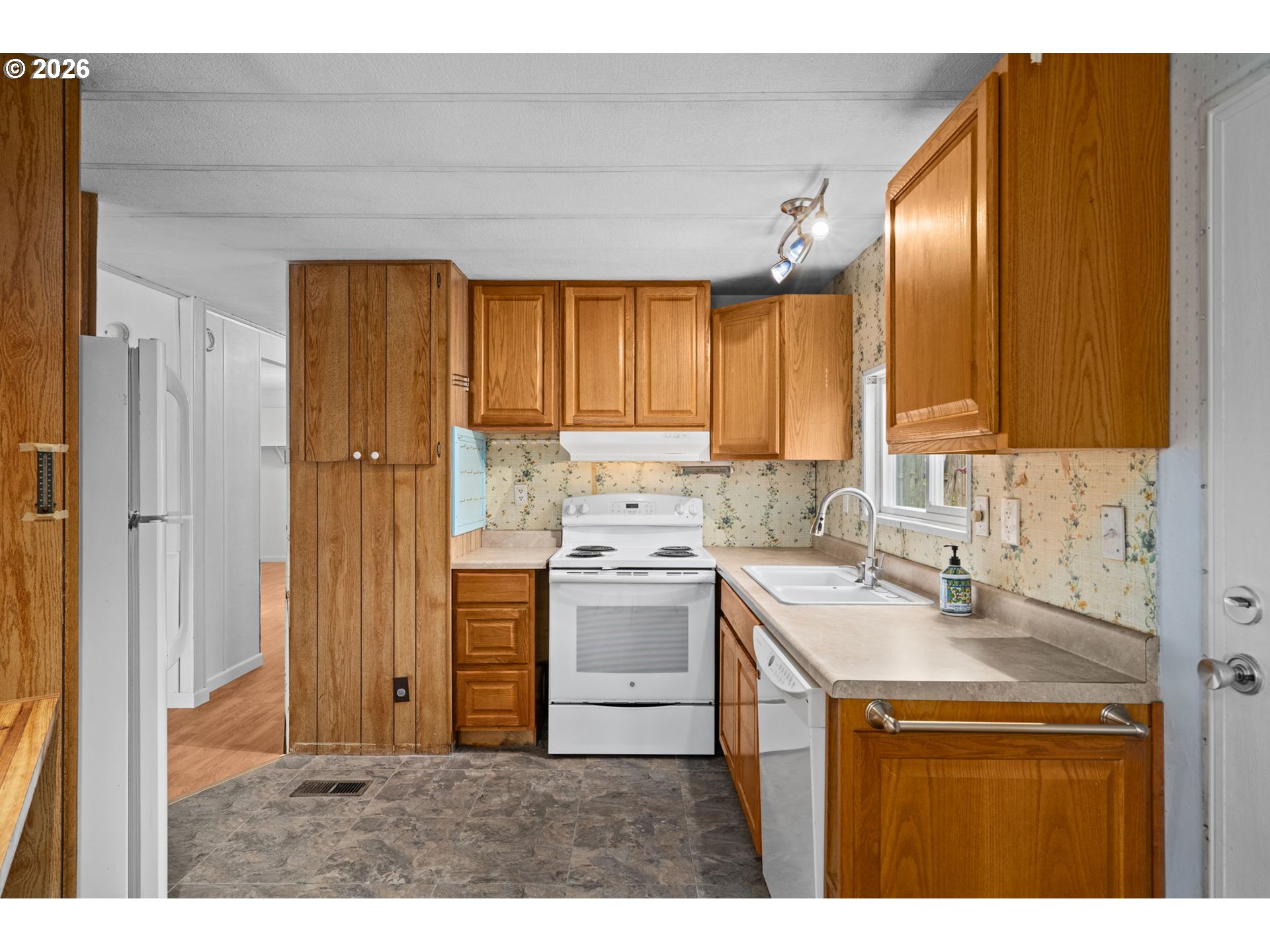 9175 Southwest Link Drive Cornelius, OR 97113 - Photo 11 of 30 a kitchen with kitchen island granite countertop stainless steel appliances a sink stove and refrigerator
