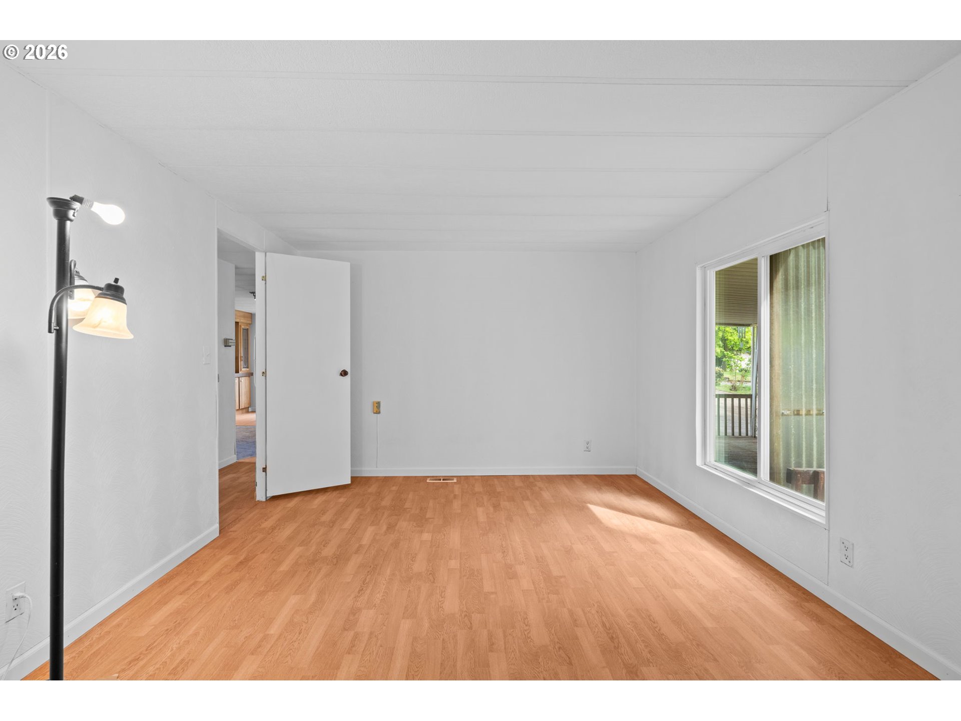 9175 Southwest Link Drive Cornelius, OR 97113 - Photo 18 of 30 a view of an empty room with wooden floor and a window