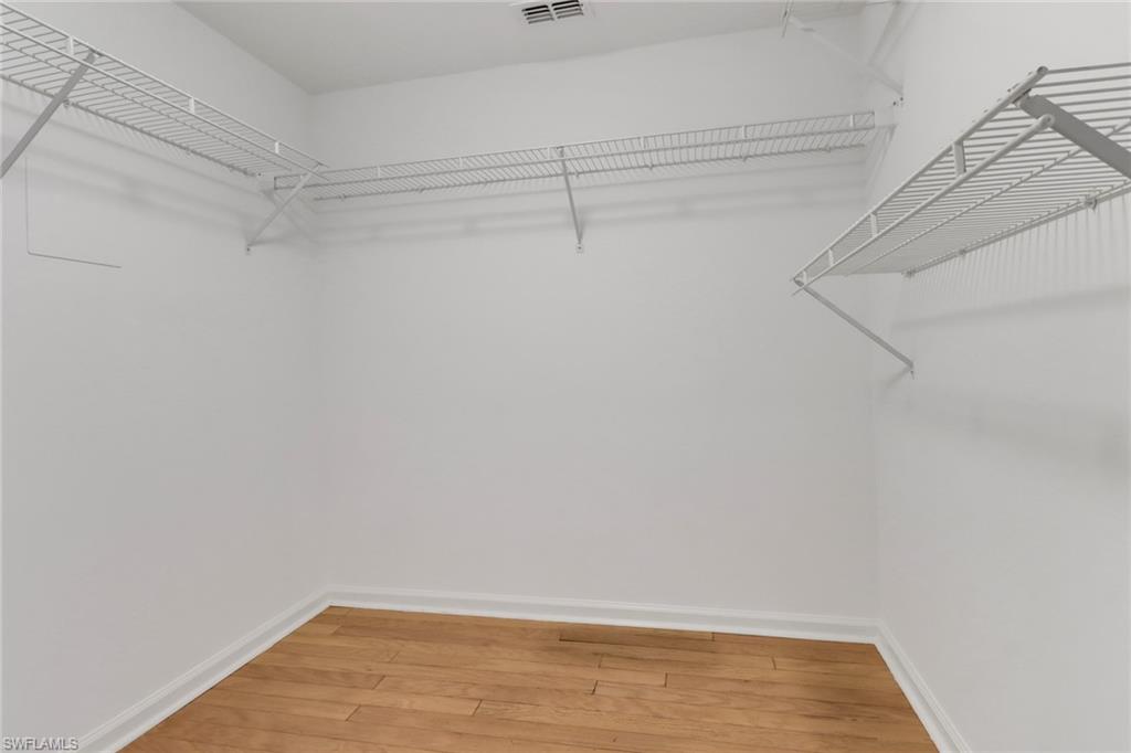 4556 Andover Way, Unit E106 Naples, FL 34112 - Photo 19 of 40 Walk in closet featuring light wood-style flooring