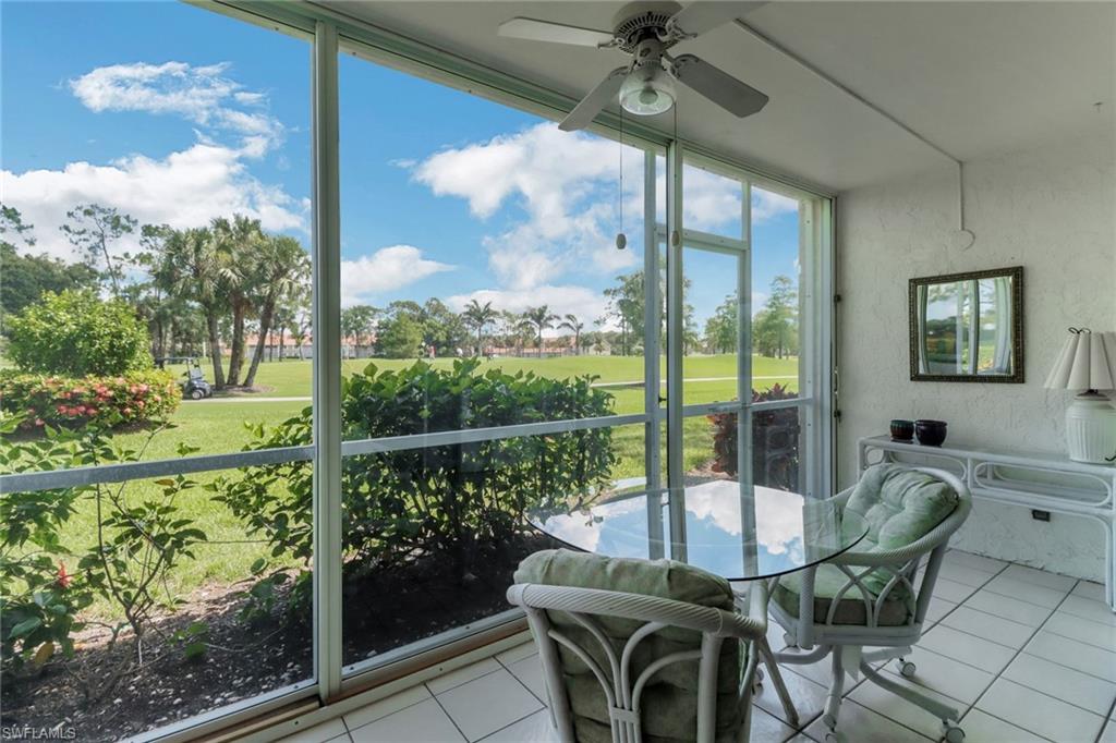 4556 Andover Way, Unit E106 Naples, FL 34112 - Photo 25 of 40 Sunroom featuring golf course view and ceiling fan