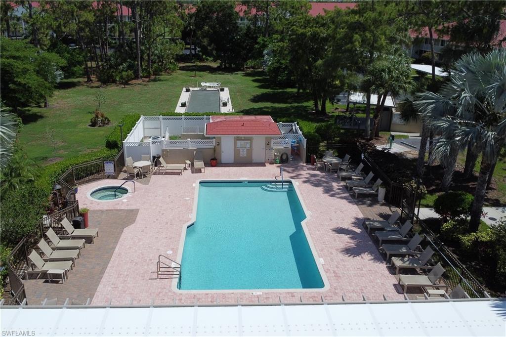 4556 Andover Way, Unit E106 Naples, FL 34112 - Photo 33 of 40 Community pool featuring a hot tub and a patio area