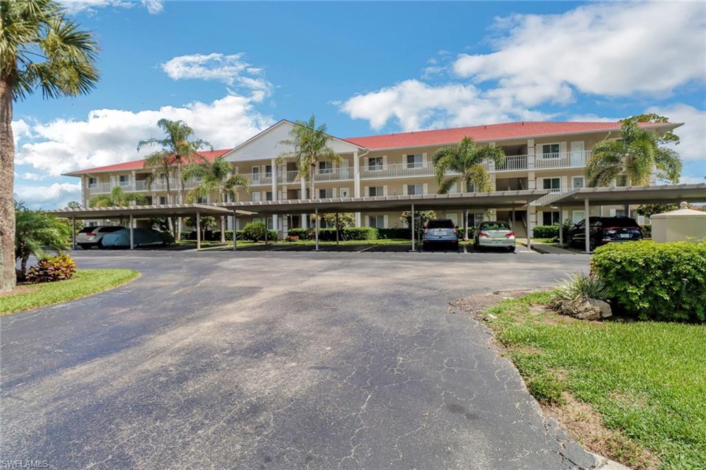 4556 Andover Way, Unit E106 Naples, FL 34112 - Photo 6 of 40 View of apartment building / complex featuring covered parking