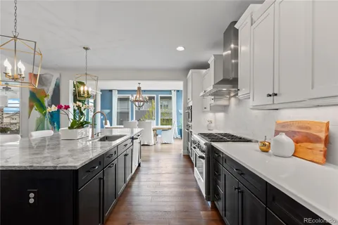 a kitchen with stainless steel appliances a sink stove and cabinets