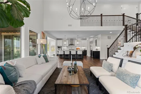 a living room with fireplace furniture and a wooden floor