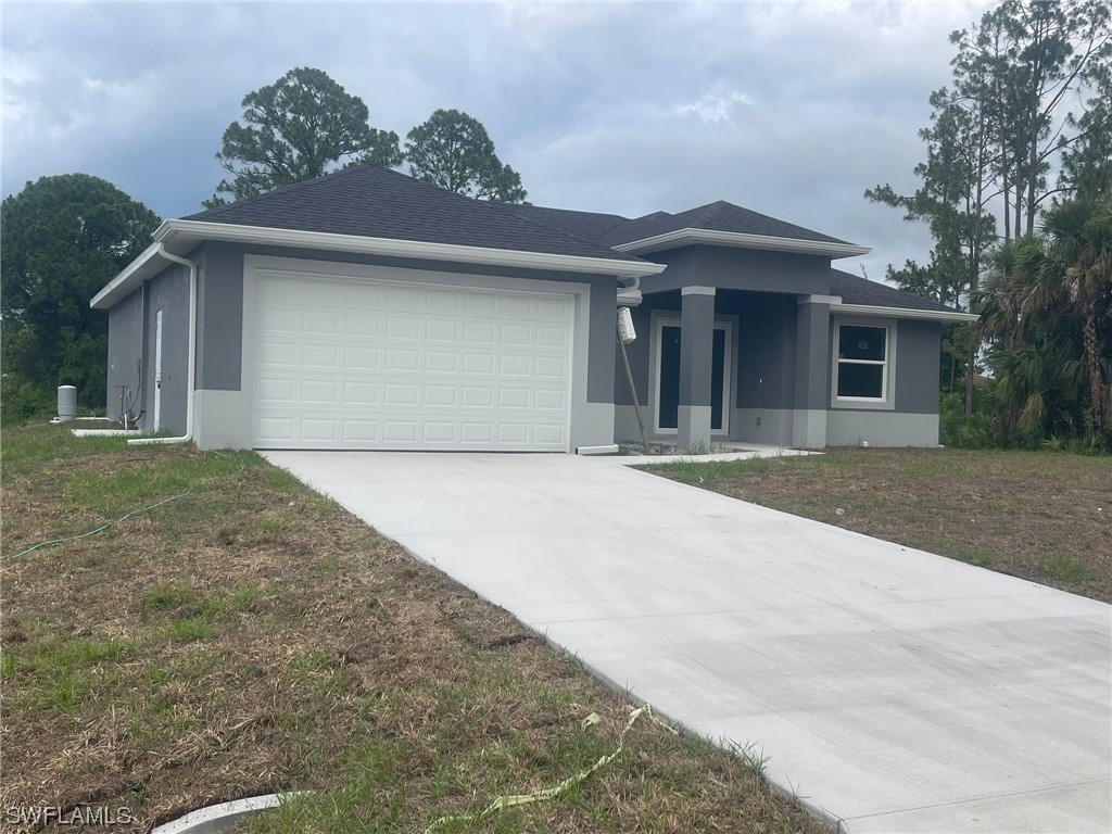 2524 39th Street West Lehigh Acres, FL 33971 - Photo 2 of 9 a front view of a house with a yard