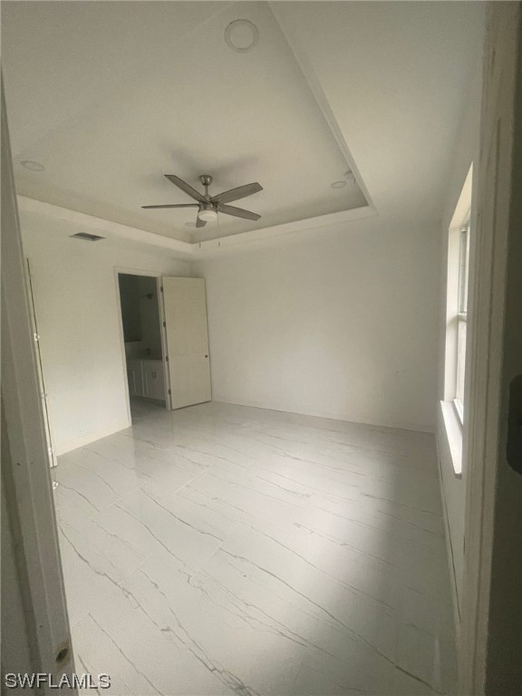 2524 39th Street West Lehigh Acres, FL 33971 - Photo 4 of 9 an empty room with a ceiling fan and window