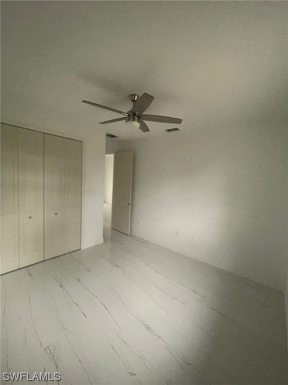 2524 39th Street West Lehigh Acres, FL 33971 - Photo 7 of 9 an empty room with a ceiling fan and a window