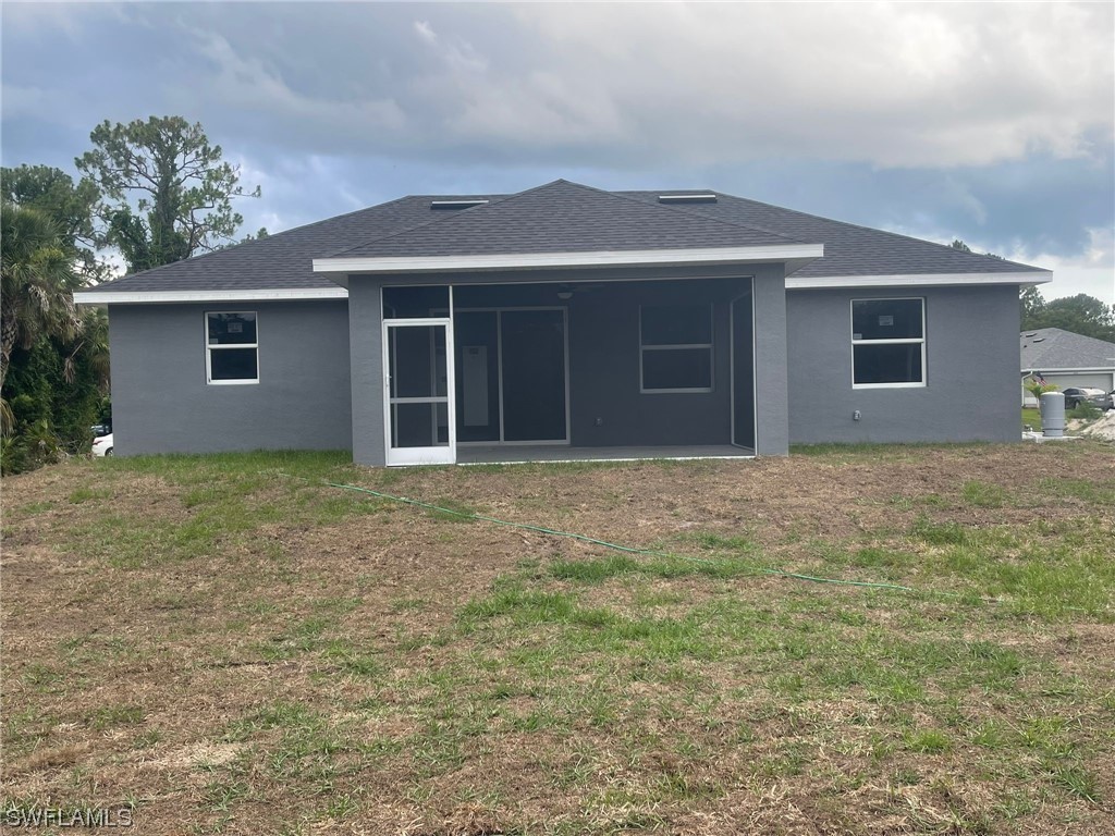 2524 39th Street West Lehigh Acres, FL 33971 - Photo 8 of 9 front view of house with a yard