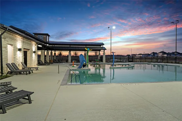 a view of swimming pool with outdoor seating and plants