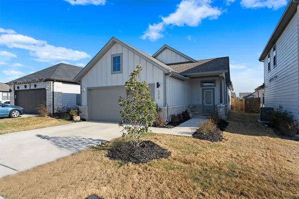 a front view of a house with a yard and outdoor seating