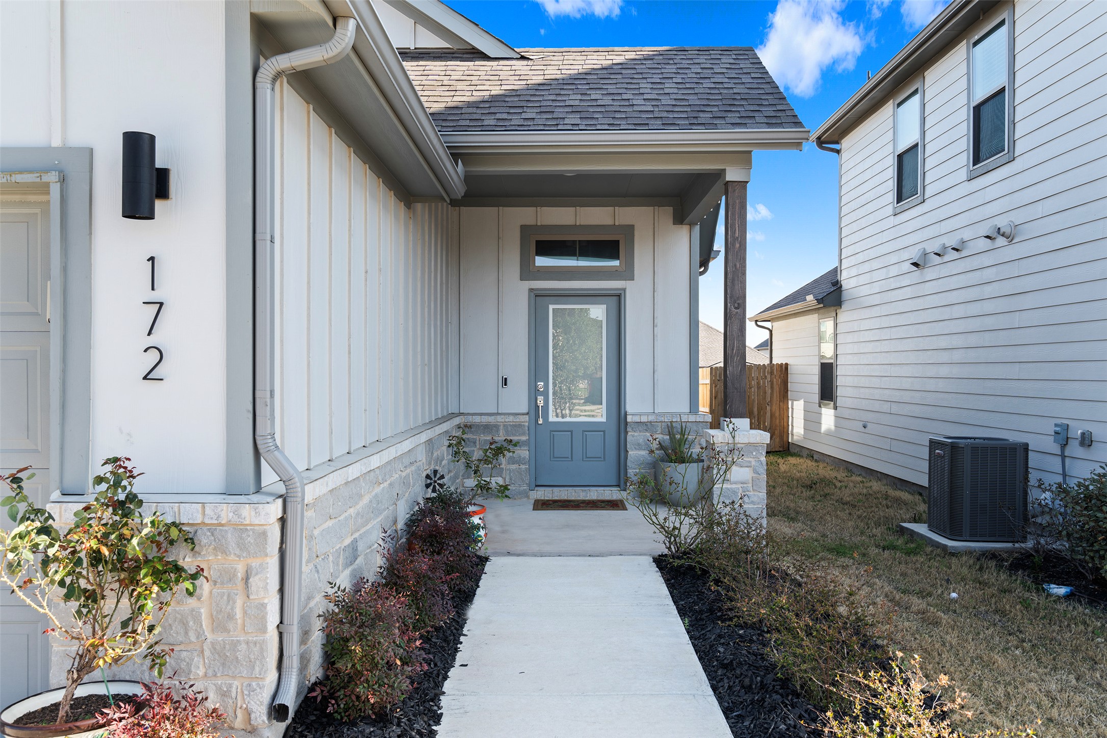 172 Gullivers Drive Elgin, TX 78621 - Photo 4 of 25 a view of a porch with potted plants