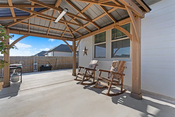 a view of a patio with table and chairs with wooden floor