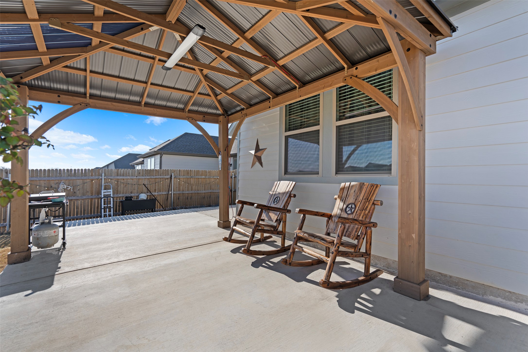 172 Gullivers Drive Elgin, TX 78621 - Photo 8 of 25 a view of a patio with table and chairs with wooden floor