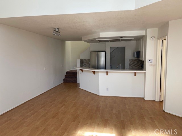 73 Fallingstar Irvine, CA 92614 - Photo 11 of 34 a view of a big room with wooden floor and hallway