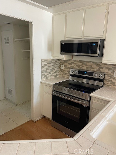 73 Fallingstar Irvine, CA 92614 - Photo 10 of 34 a stove top oven sitting inside of a kitchen