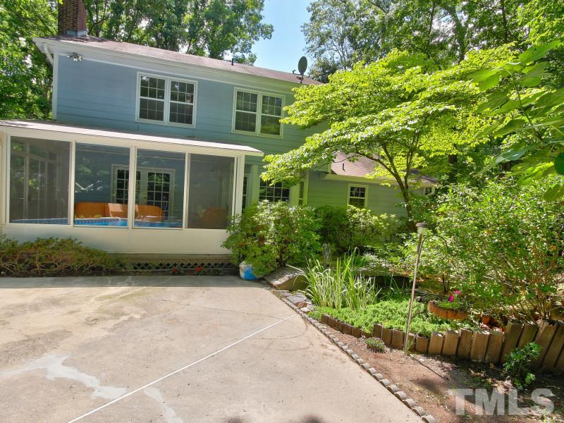 2801 Steeplechase Court Raleigh, NC 27613 - Photo 22 of 23 a view of a house with potted plants and large trees