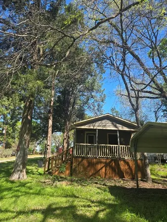 a view of house with a yard