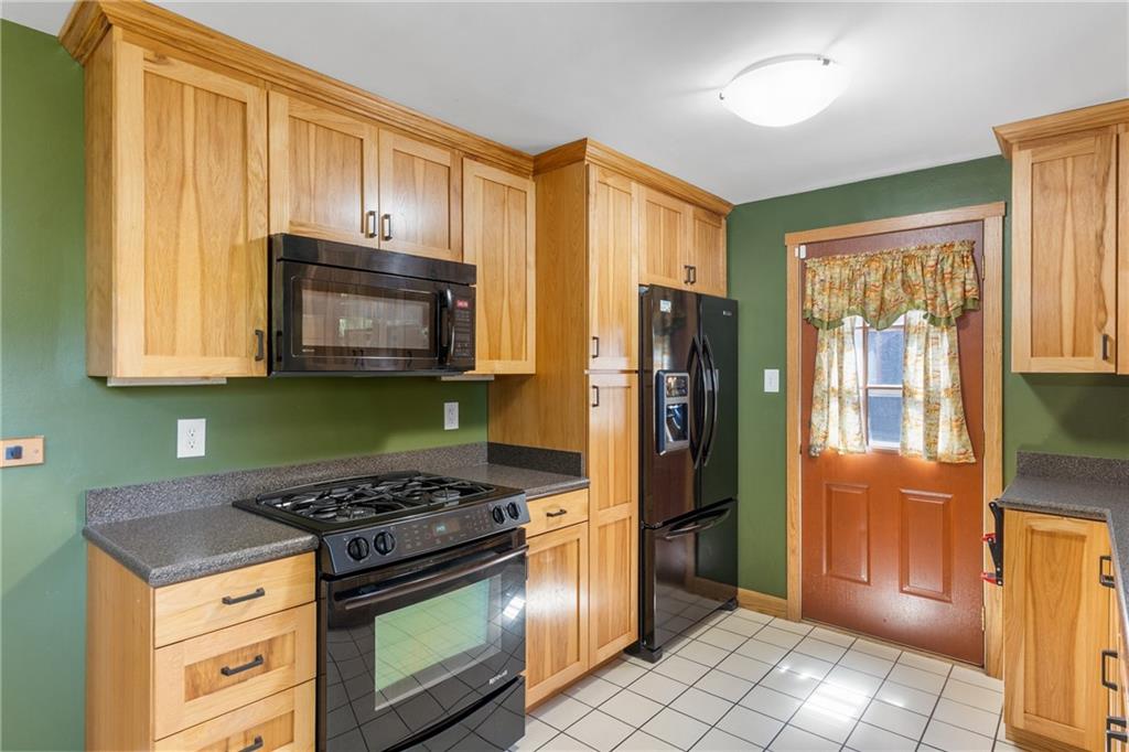 1017 Silver Lane McKees Rocks, PA 15136 - Photo 10 of 34 a kitchen with stainless steel appliances granite countertop a stove a refrigerator and a cabinets