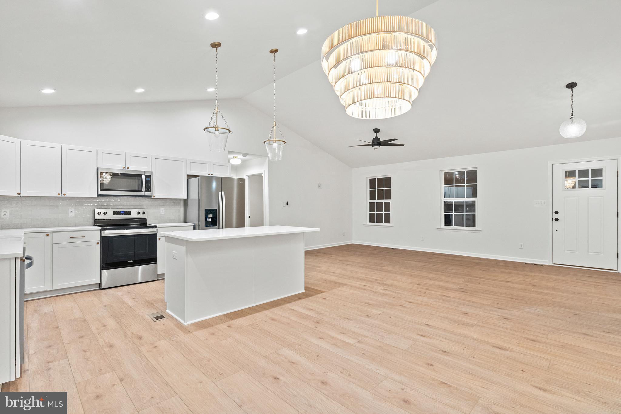 1080 Eastham Road Bumpass, VA 23024 - Photo 12 of 43 a kitchen with stainless steel appliances granite countertop a stove a sink and white cabinets with wooden floor