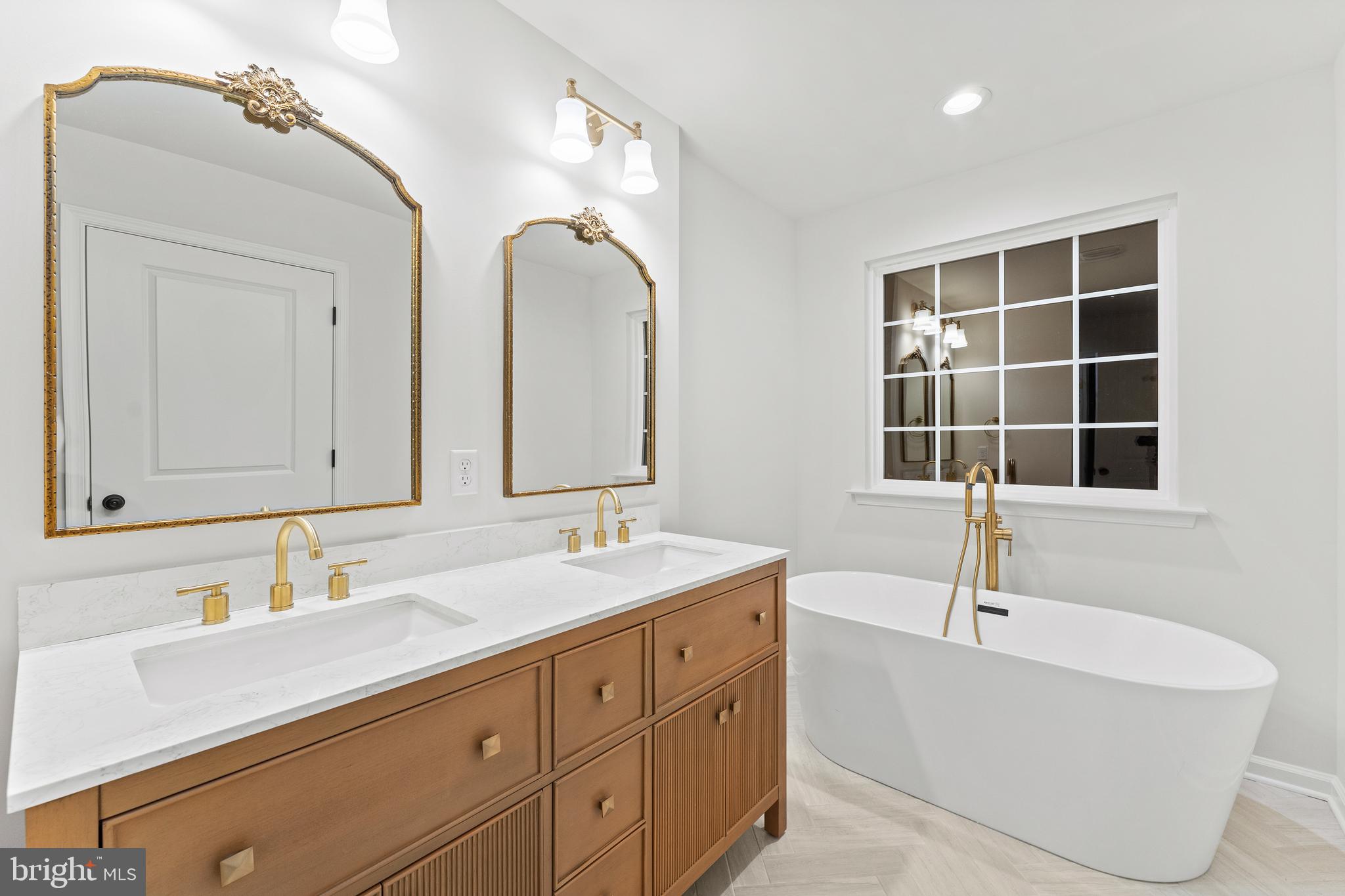 1080 Eastham Road Bumpass, VA 23024 - Photo 18 of 43 a bathroom with a tub sink double vanity and mirror