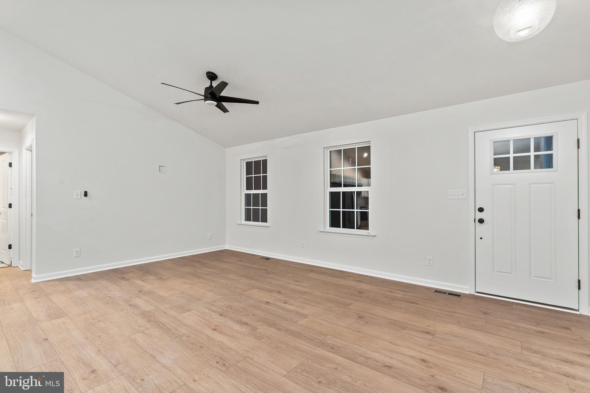 1080 Eastham Road Bumpass, VA 23024 - Photo 3 of 43 an empty room with windows and ceiling fan