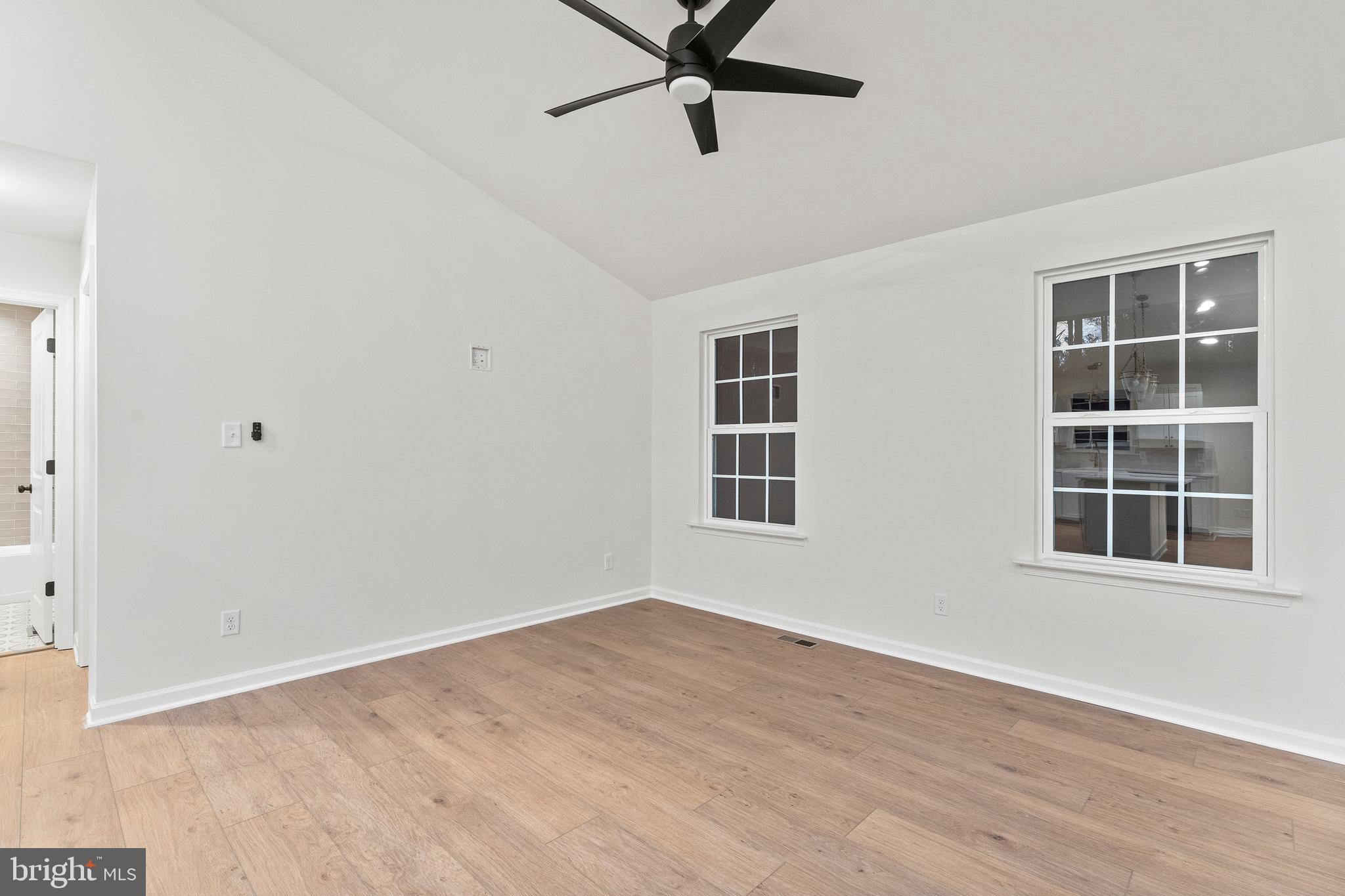 1080 Eastham Road Bumpass, VA 23024 - Photo 4 of 43 a view of an empty room with a window and wooden floor