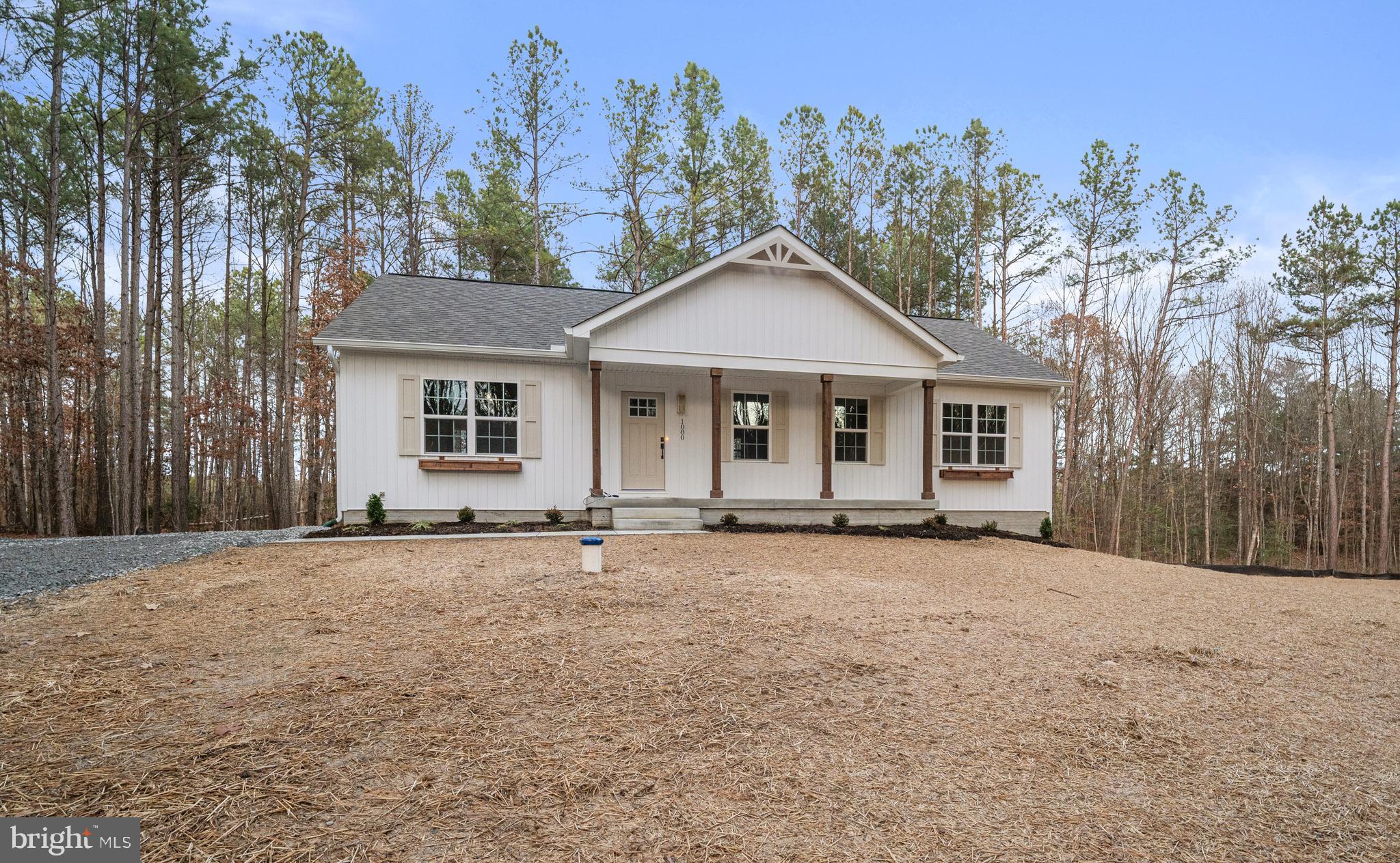 1080 Eastham Road Bumpass, VA 23024 - Photo 43 of 43 a front view of a house with a garden and trees