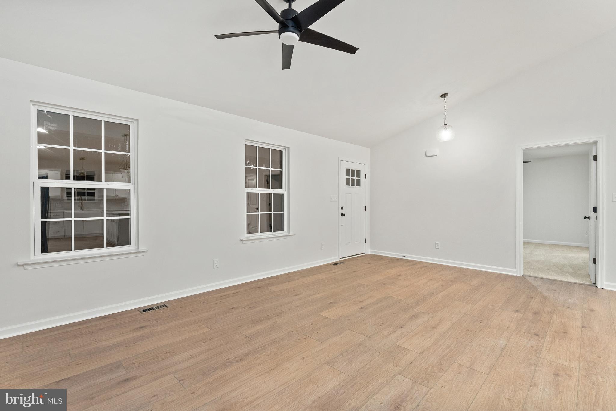 1080 Eastham Road Bumpass, VA 23024 - Photo 5 of 43 a view of an empty room with a window and wooden floor